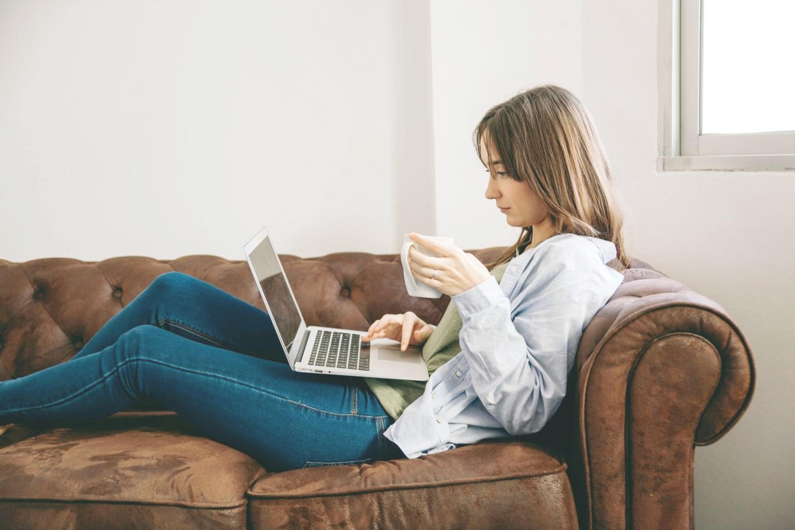 Business professional analyzing financial data and charts on laptop